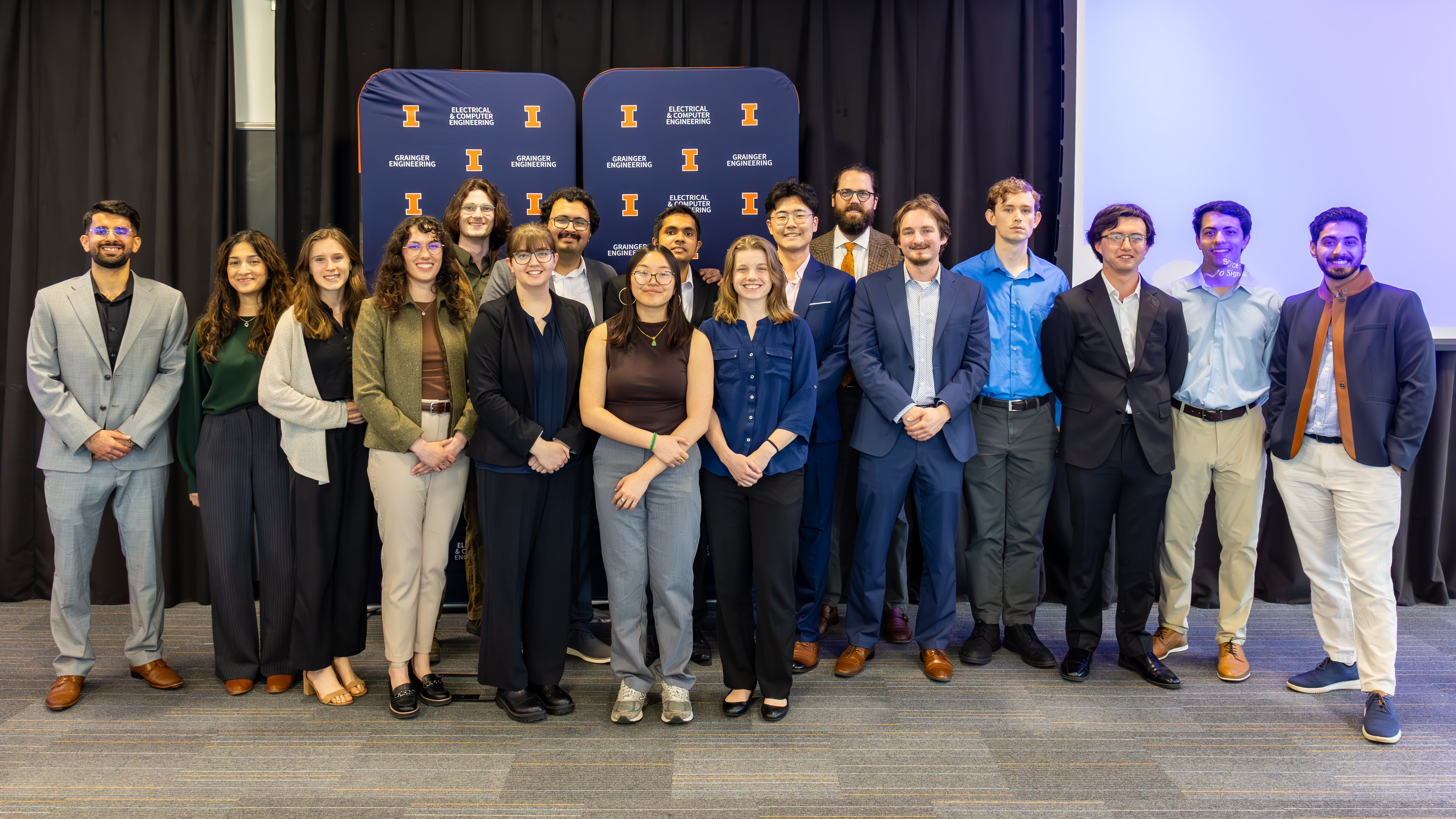 PECI 2026 team posing in front of two U. of I. backdrops