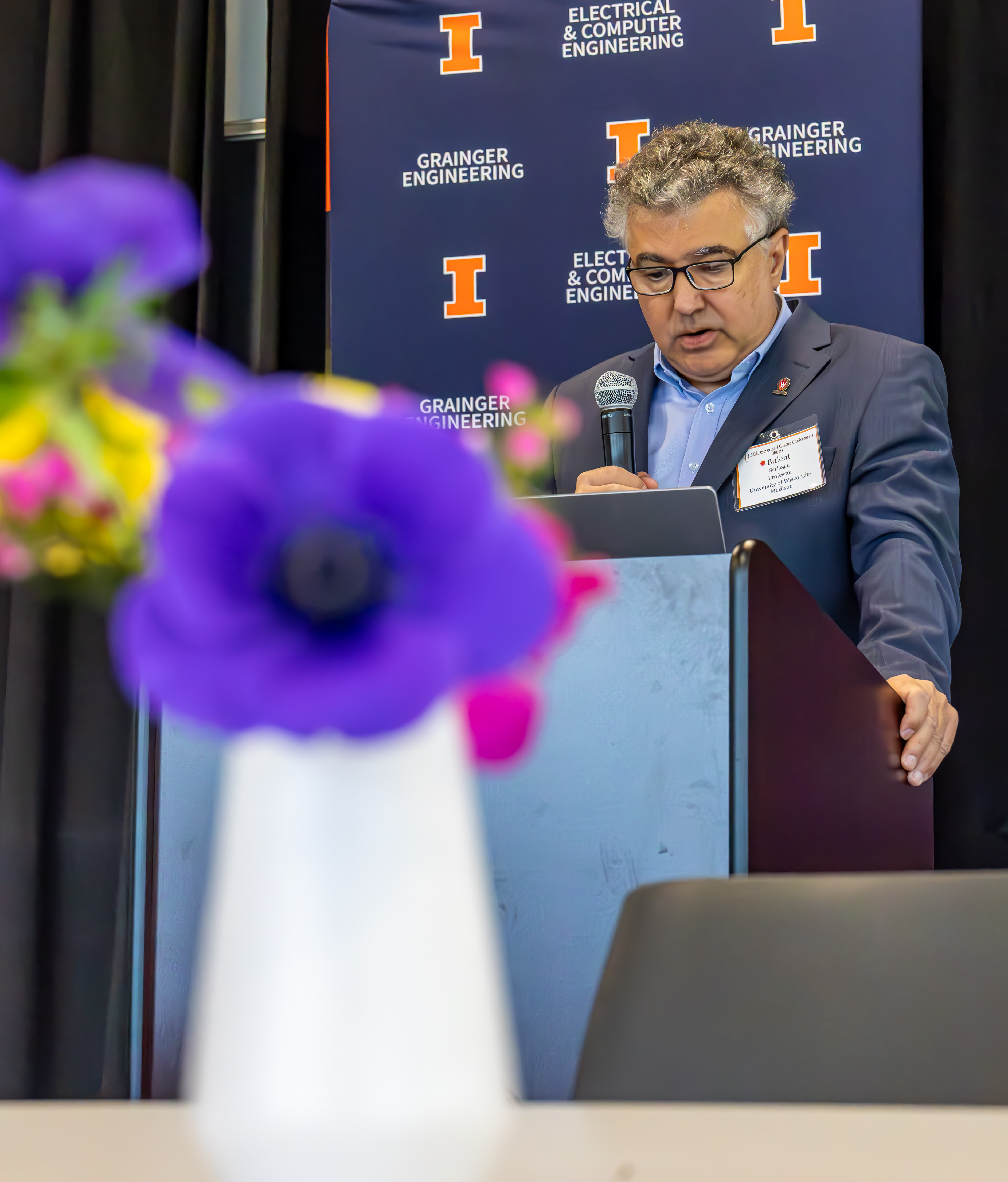 UW Professor Bulent Sarlioglu speaks at a podium