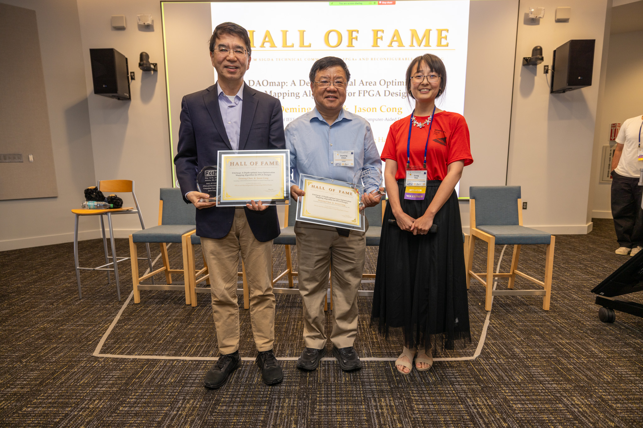 UCLA professor Jason Cong, ECE professor Deming Chen, and Georgia Tech professor Callie Hao stand smiling with award certificates