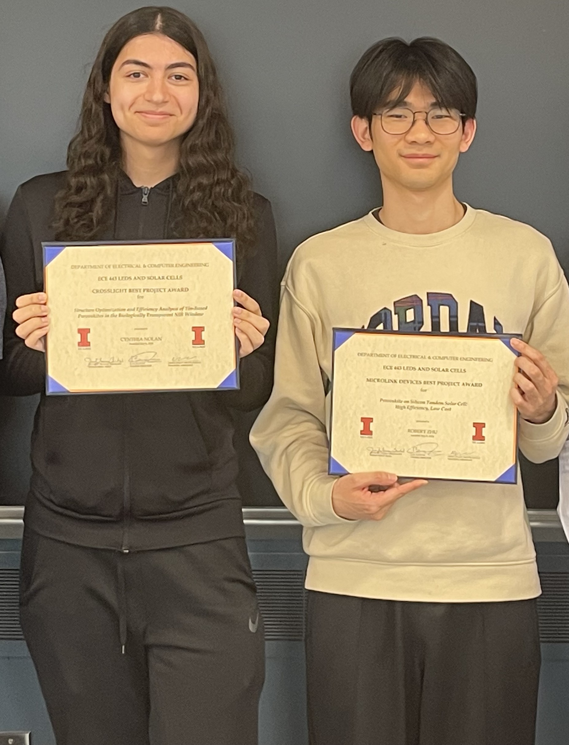 ECE 443 awardees Cynthia Nolan (left) and Robert Zhu (right) hold their certificates