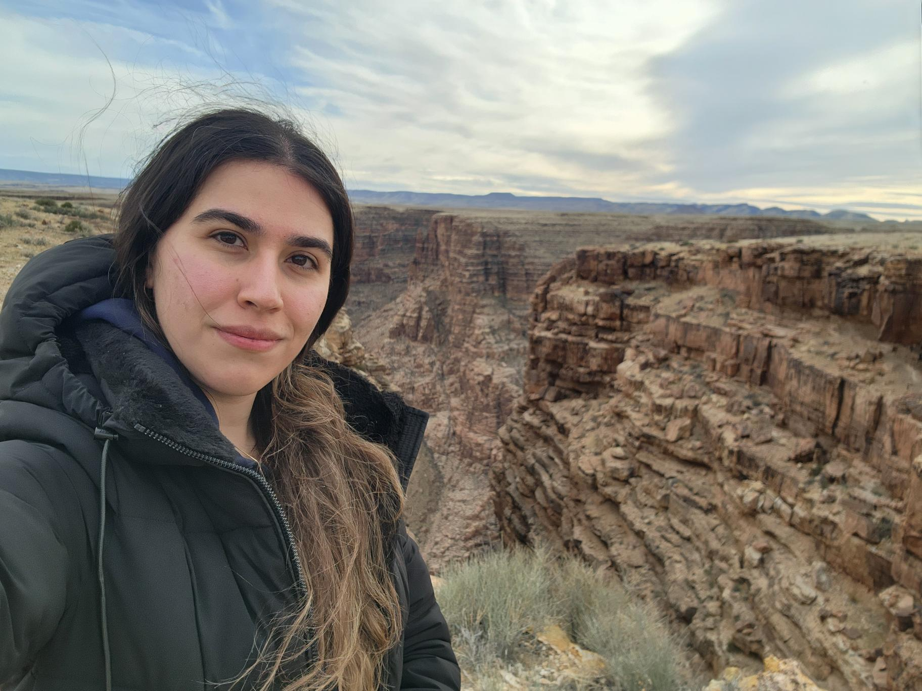 Photo is from first trip to Navajo Nation in Arizona for research on off-grid electrification featuring Melody Famil Rasoulian in the foreground with the rocky landscape of Arizona behind her