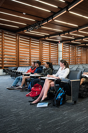 students sitting in lecture hall taking notes