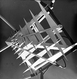 Array of four triangular tooth log-periodic antennas used for reflector feeds.