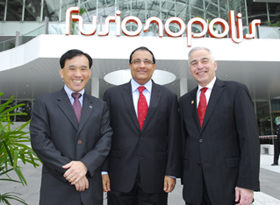 A*Star Chairman Lim Chuan Poh (left), Senior Minister of State for Trade and Industry S. Iswaran, and Illinois Chancellor Richard Herman stand outside the Fusionopolis building in Singapore after the February 12 opening ceremony for the Advanced Digital Sciences Center.