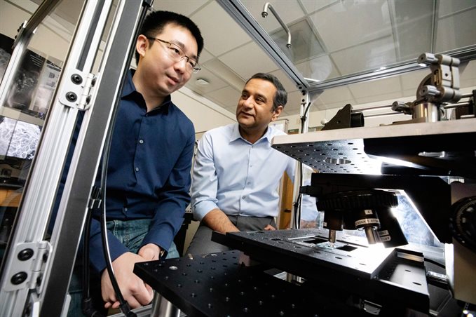 Rohit Bhargava with postdoctoral researcher Kevin Yeh, who designed the custom infrared microscope used for this study. This photo was taken in February 2020.