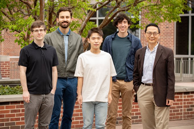 The research team included, from front left, Stephan Lane, manager of the Illinois Biological Foundry for Advanced Biomanufacturing; graduate student Guanhua (Daniel) Xun; Huimin Zhao, the Steven L. Miller Chair of chemical and biomolecular engineering, and a professor of chemistry, biochemistry, biophysics, and bioengineering. In back, from left, electrical and computer engineering undergraduate student Vassily Petrov; and mechanical science and engineering undergraduate student Brandon Pepa, who recently graduated. (Photo by L. Brian Stauffer)