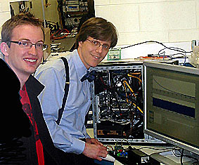 ECE graduate student Michael Wayne (left) and Physics Professor Paul G. Kwiat at work in Kwiat's lab. Photo by R. Hohenstein.