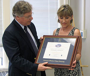 At a reception held June 20, ECE Department Head Andreas Cangellaris (left) presents Vicki Brown-Mowery with a certificate recognizing her 25 years of service to the University and the Department of Electrical and Computer Engineering.