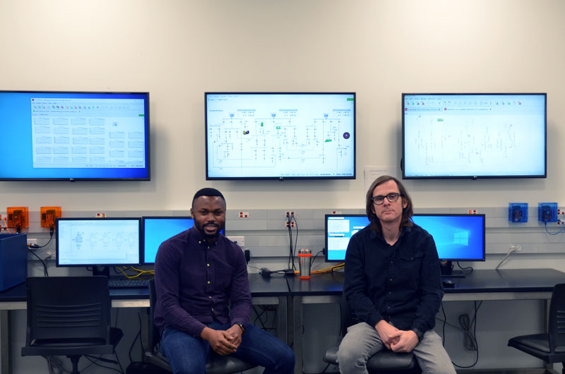 Research Engineer Olaolu Ajala (left) and Professor Alejandro Dominguez-Garcia (right) in their lab.