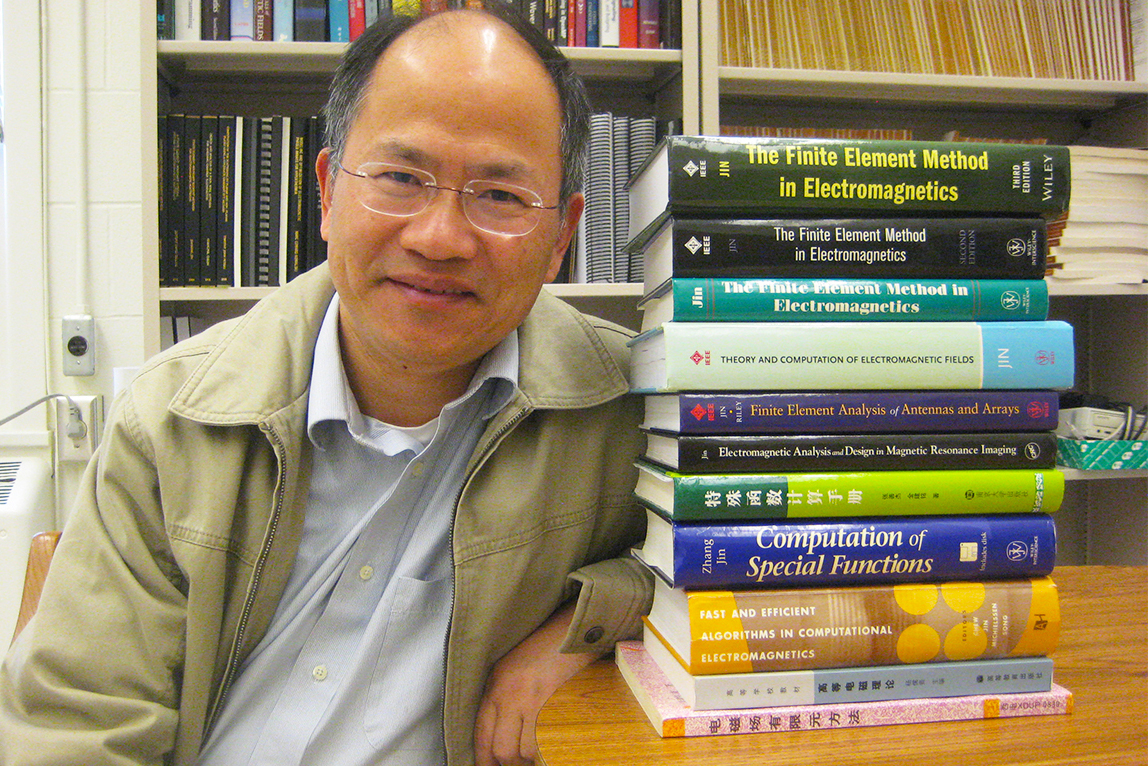 Jianming Jin with books he's authored, including the most recent at top.