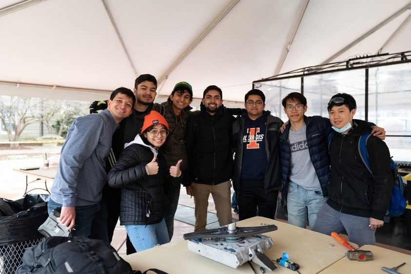 "Budget Extensions" was one of 20 robots that competed in the 2022 Robobrawl competition April 8-9. Team members are (left to right) Justin Ansell (CompE), Ahmed Baig (above, CEE), Diane Gonzalez (below, MechSE), Aman Penmetcha (MechSE), Mahir Patel (Aero), Riten Mehta (MechSE), Thomas Nguyen (MechSE), Matthew Zhang (MechSE)