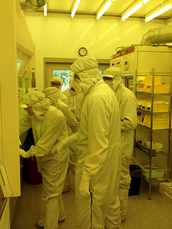 RET teachers learn how to spin coat PEDOT:PSS and fabricate solar cells in the MNTL cleanroom, under the direction of graduate student Lisa Plucinski.