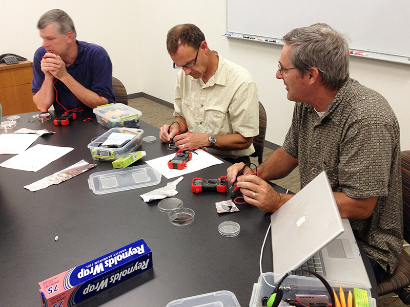 RET teachers Dan Reid, David Bergandine and Terry Koker (left to right) test their solar cells.