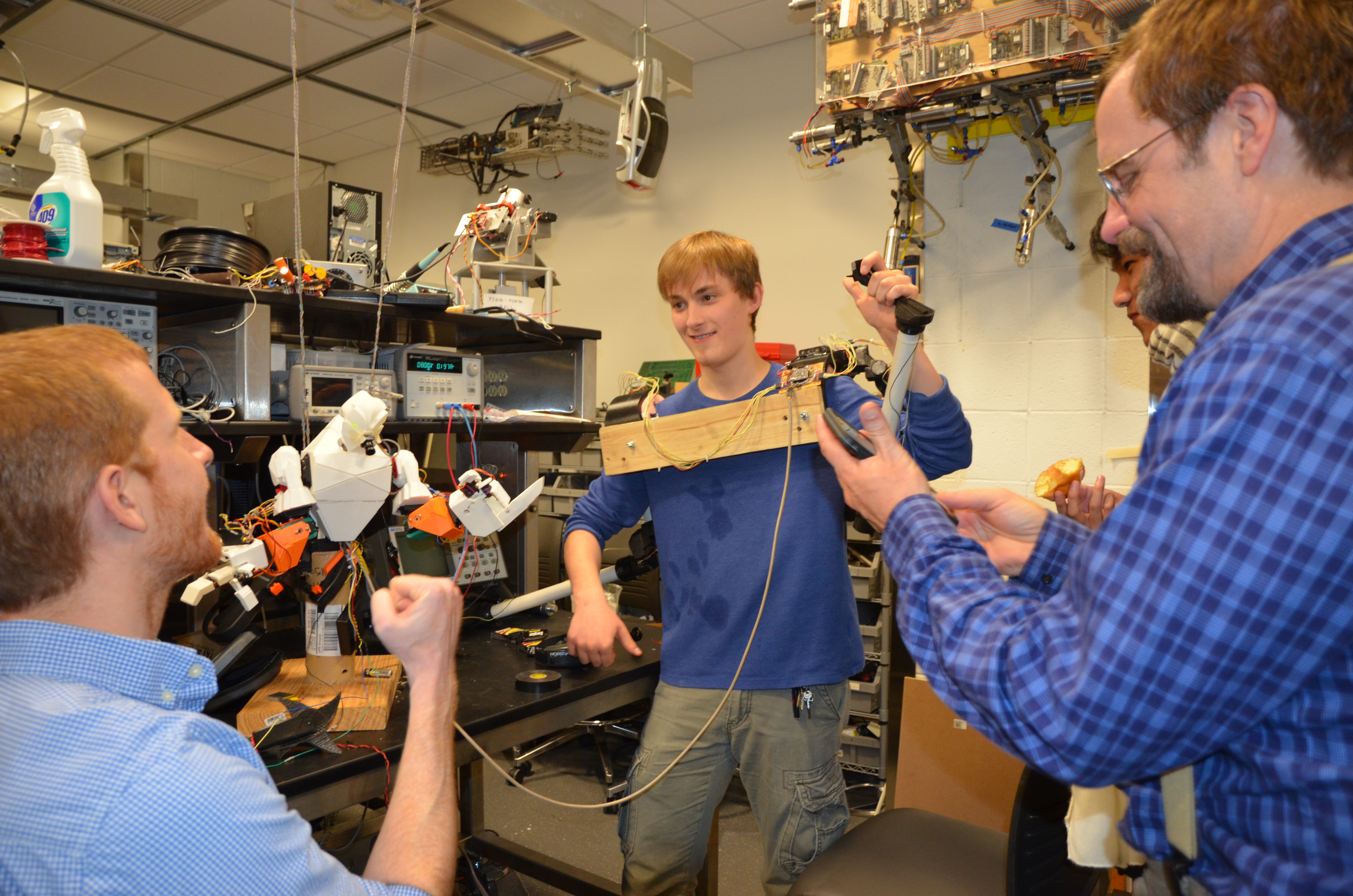 Jesse Cornman showing professors how his robot works.