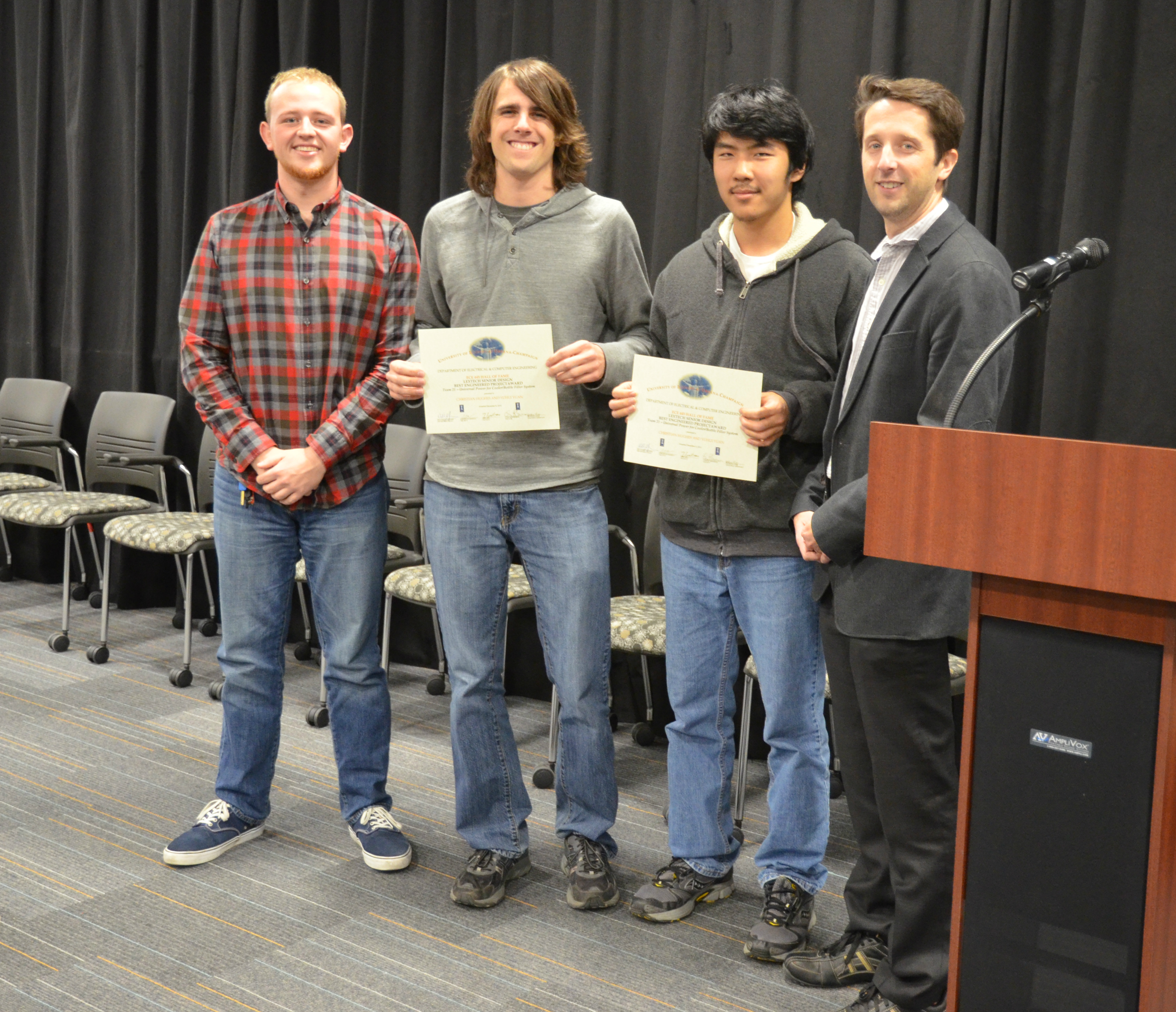 Team 21's project, 'Universal Power for Cooler/Bottle Filler System,' won the Lextech Senior Design Best Engineered Project Award. Team members: Christian Hughes and Yuhui Yuan. Also pictured: Jackson Lenz (TA) and Professor Makela.