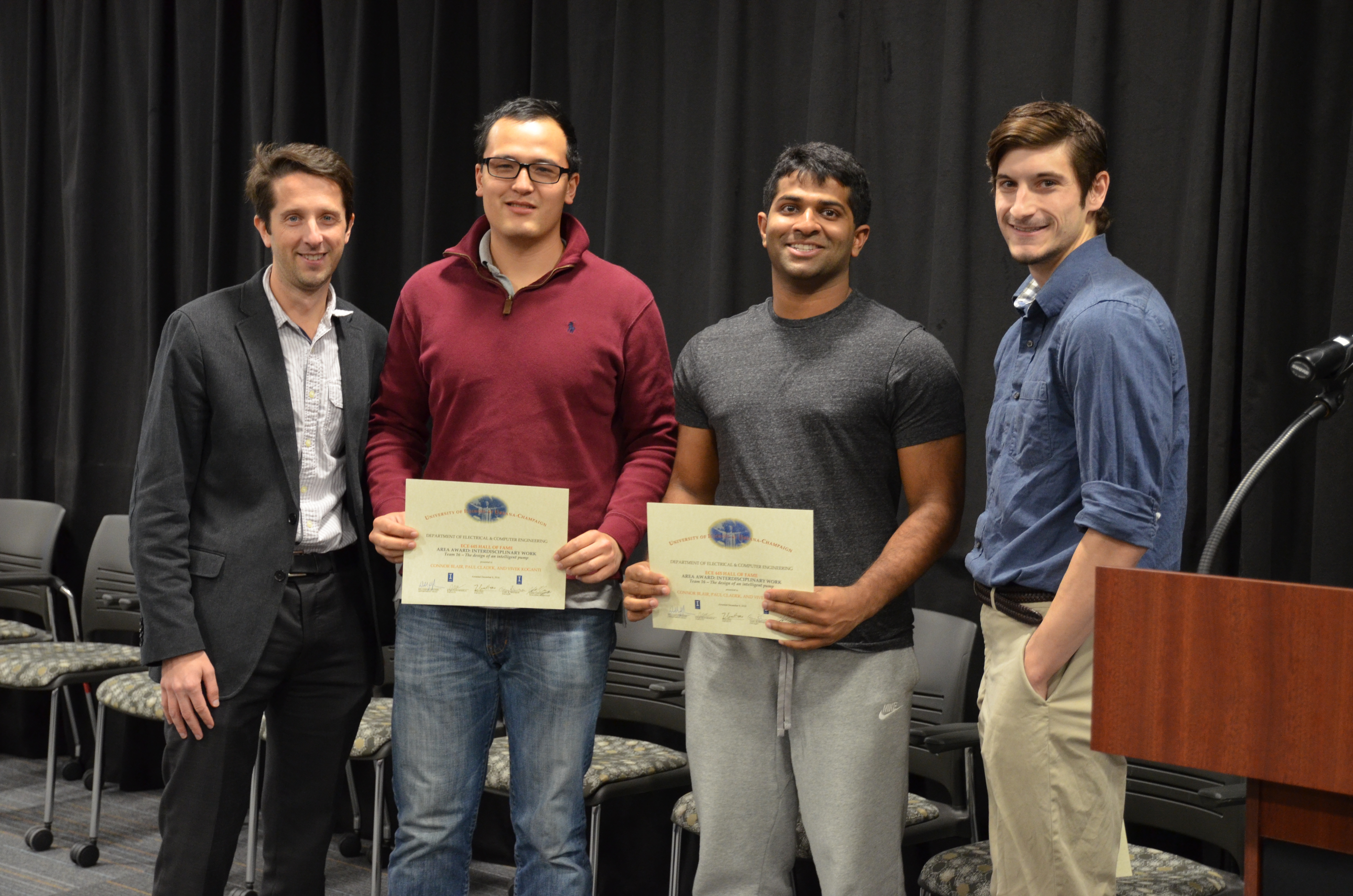 The Area Award for Interdisciplinary Work was awarded to Team 16 for 'The Design of an Intelligent Pump.' Team members: Connor Blair, Paul Cladek, and Vivek Koganti. Also pictured: John Capozzo (TA) and Professor Makela.