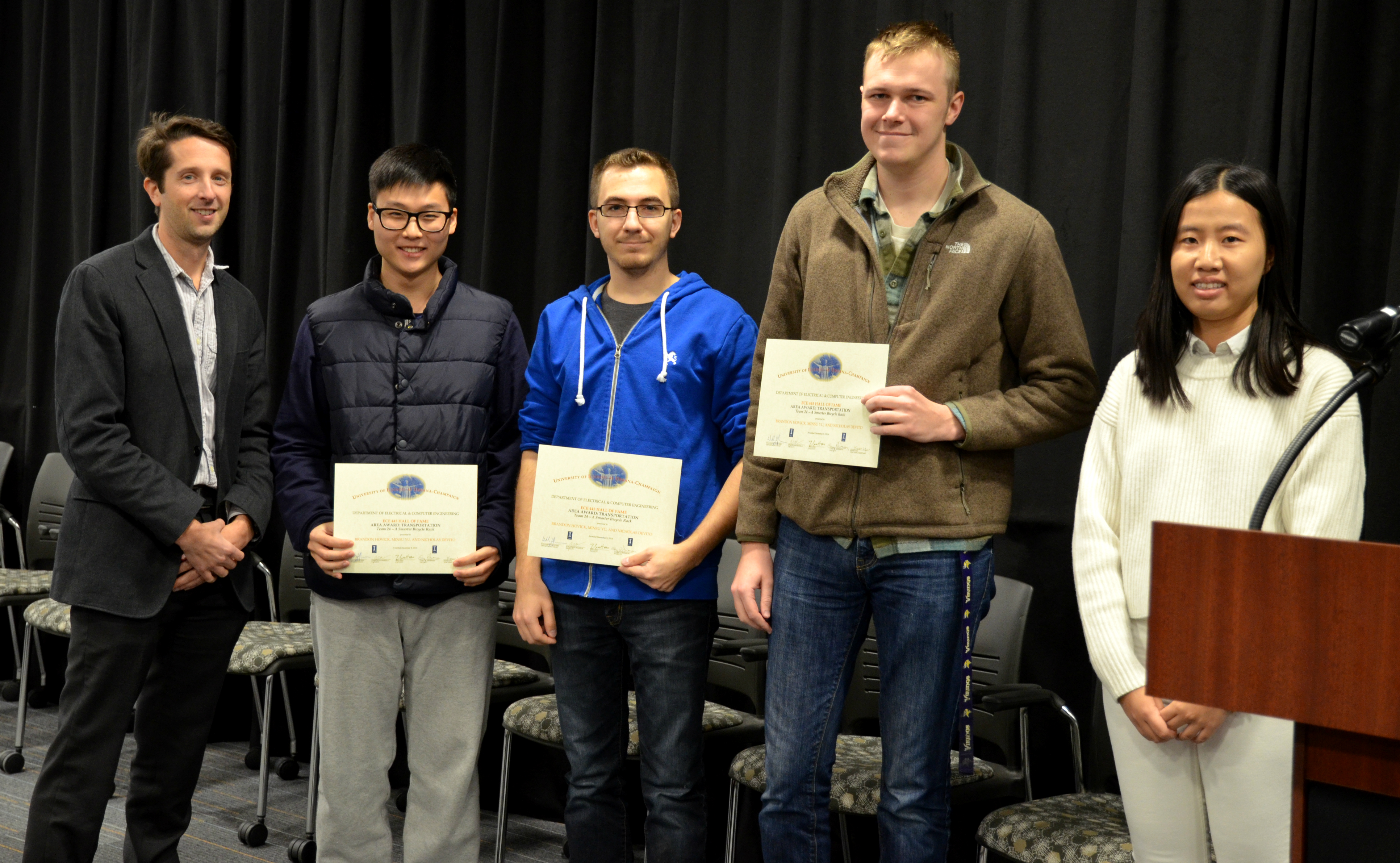 The Area Award for Transportation was awarded to Team 24 for 'A Smarter Bicycle Rack.' Team members: Brandon Hovick, Minsu Yu, and Nicholas Devito. Also pictured: Kexin Hui (TA) and Professor Makela.