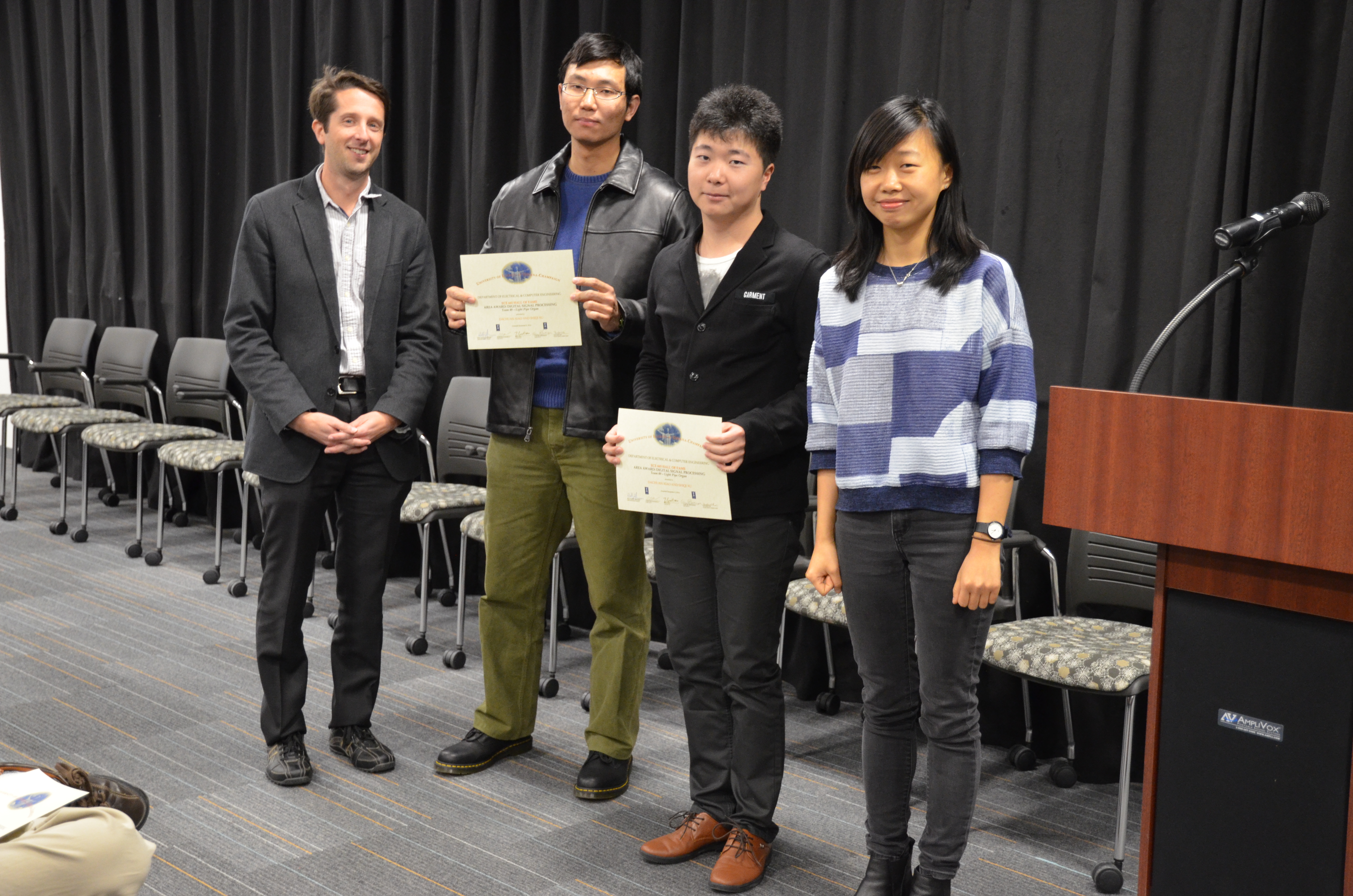 The Area Award for Digital Signal Processing is awarded to Team 49 for their 'Light Pipe Organ.' Team members: Dachuan Xiao and Shiqi Xu. Also pictured: Yuchen He (TA) and Professor Makela.