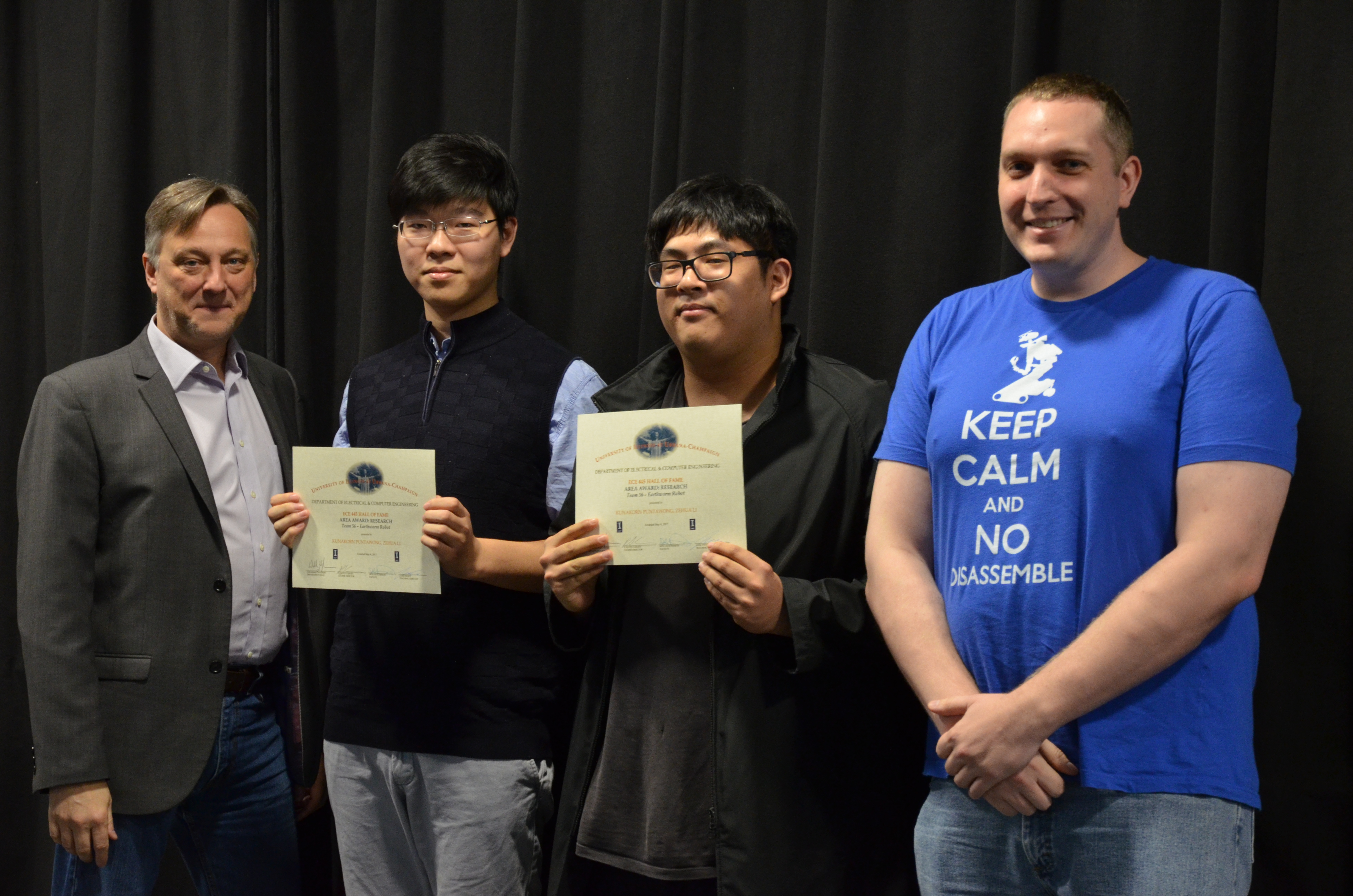 The Area Award for Research is presented to Kunakorn Puntawong and Zehua Li for their 'Earthworm Robot.' Also pictured: Professor Hutchinson, Luke Wendt (TA).