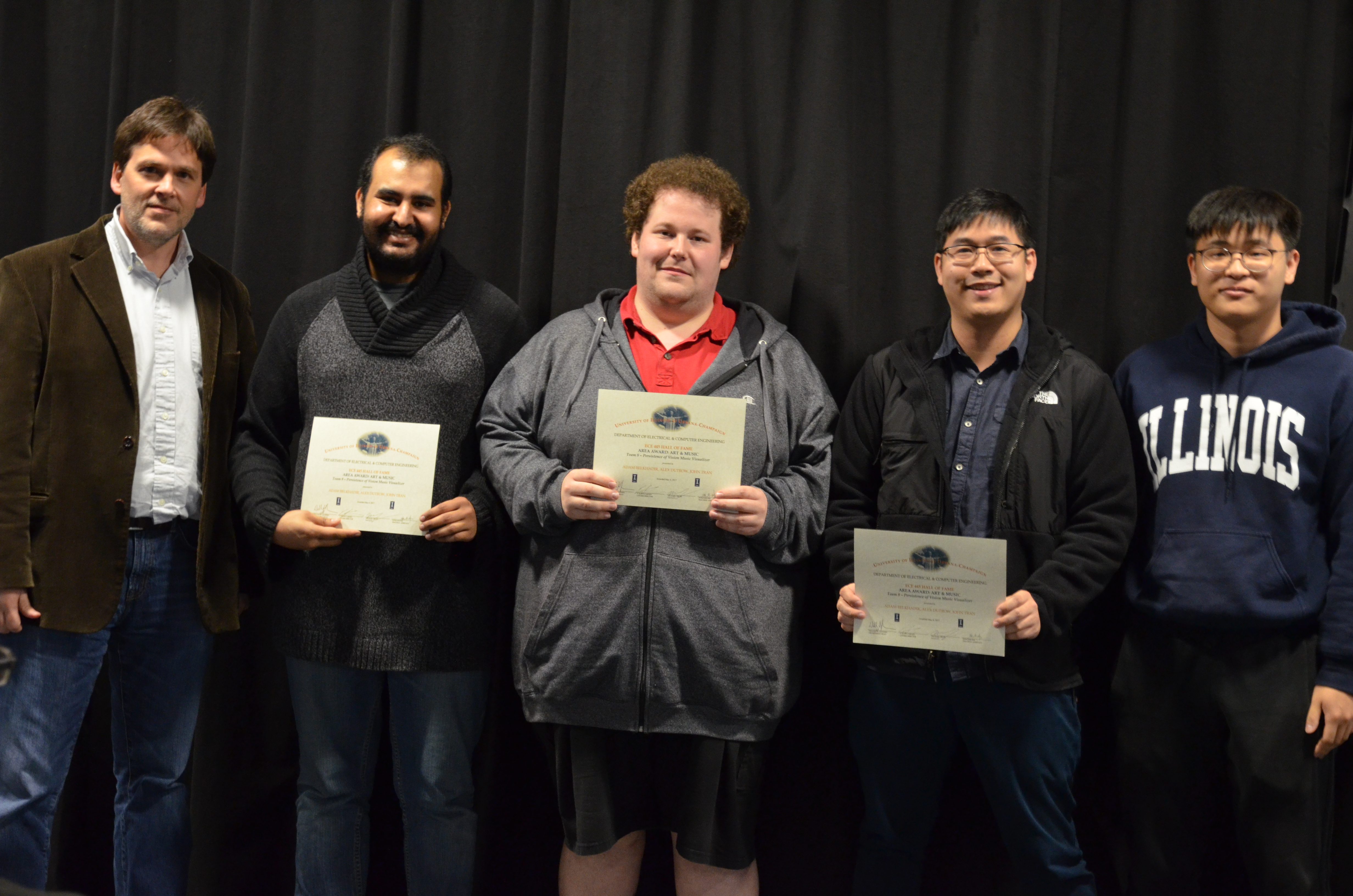 The Area Award for Art and Music is presented to Adam Belkhadir, Alex Dutrow and John Tran for their 'Persistence of Vision Music Visualizer.' Also pictured: Professor Oelze, Dongwei Shi (TA).
