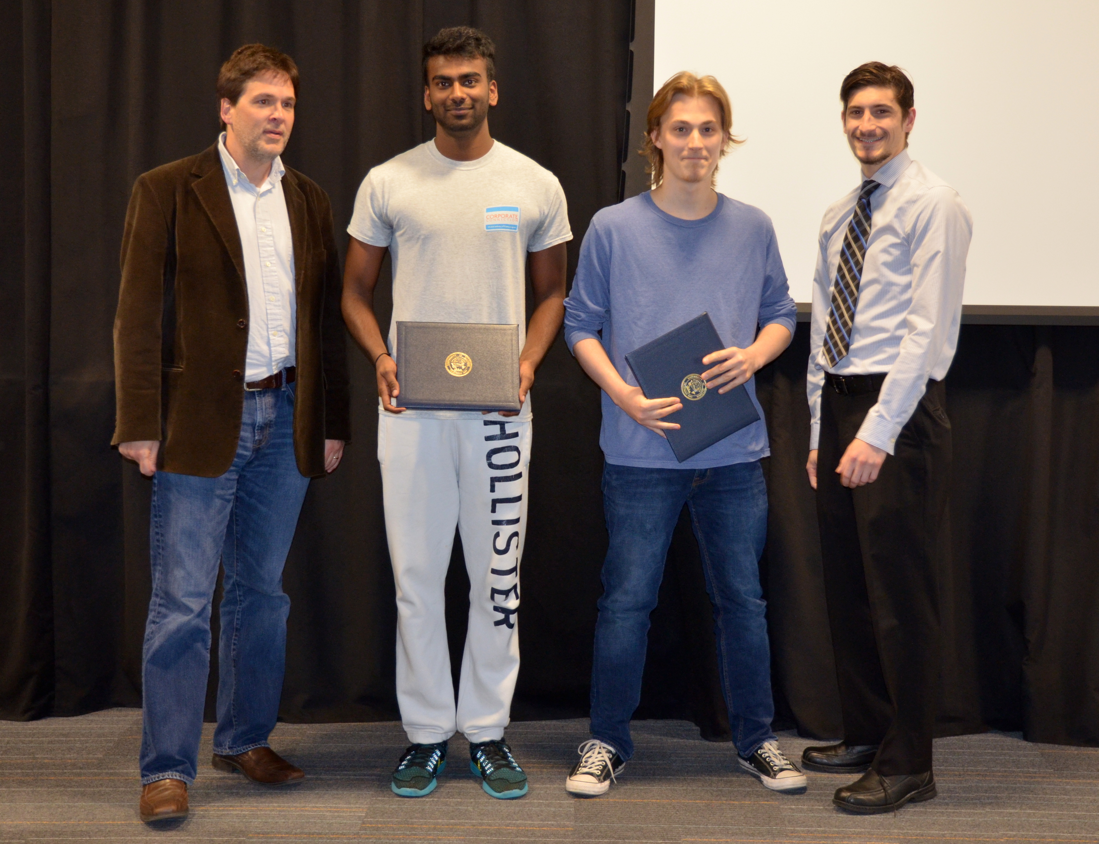 The Michelle and Alex Bratton Senior Design Instructor's award is presented to Vikram Mudaliar and Jesse Cornman for their 'Portable Multi-Channel Electrotactile Haptic Feedback System.' Also pictured: Professor Oelze, John Capozzo (TA).