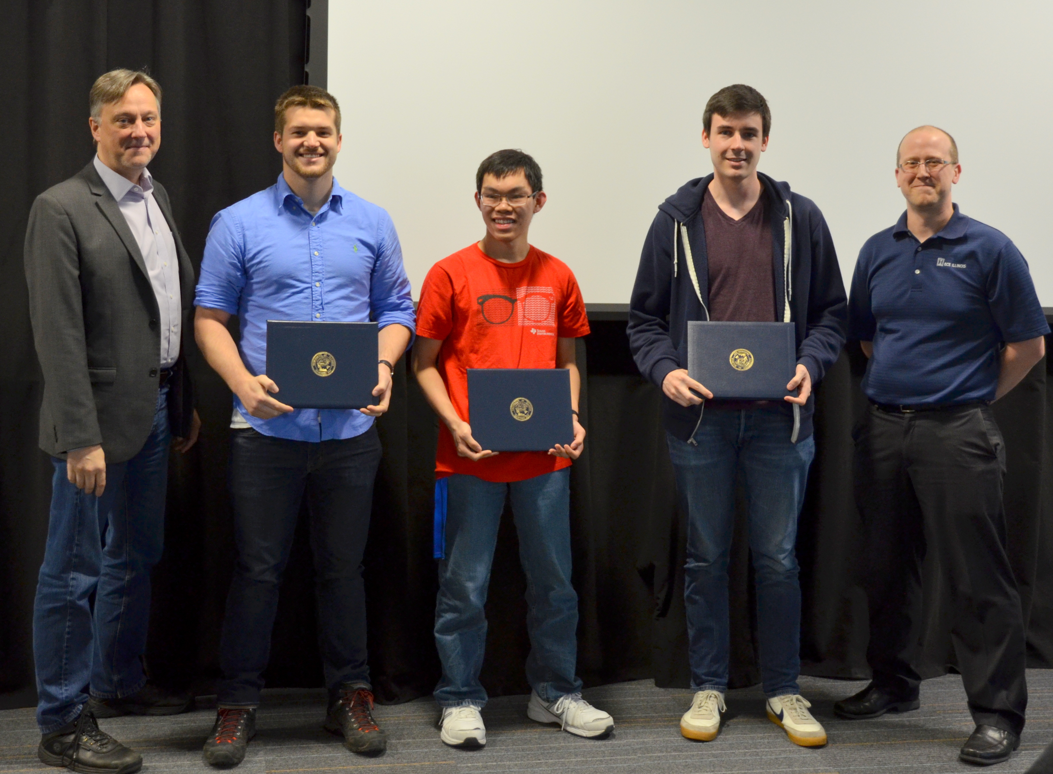 The Lextech Senior Design Award for Best Engineerd Project is given to Michael Genovese, Nicholas Denardo and Timothy Wong for their 'American Alphabet Sign Language Interpreter.' Also pictured: Professor Hutchinson, Jacob Bryan (TA).