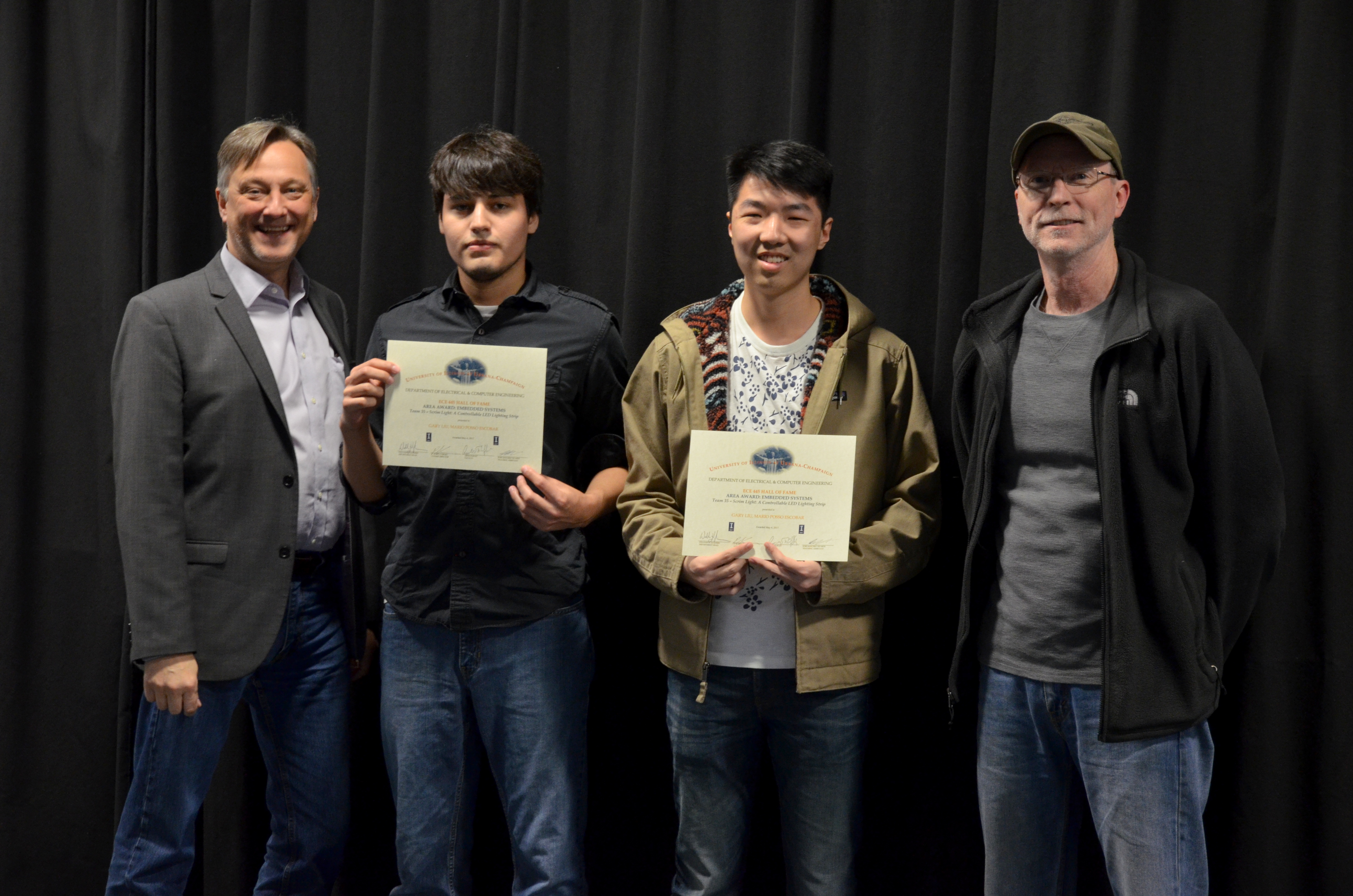 The Area Award for Embedded Systems is presented to Gary Liu and Mario Escobar for their 'Scrim Light: A Controllable LED Lighting Strip.' Also pictured: Professor Hutchinson,  Rick Kessinger (Sponsor).