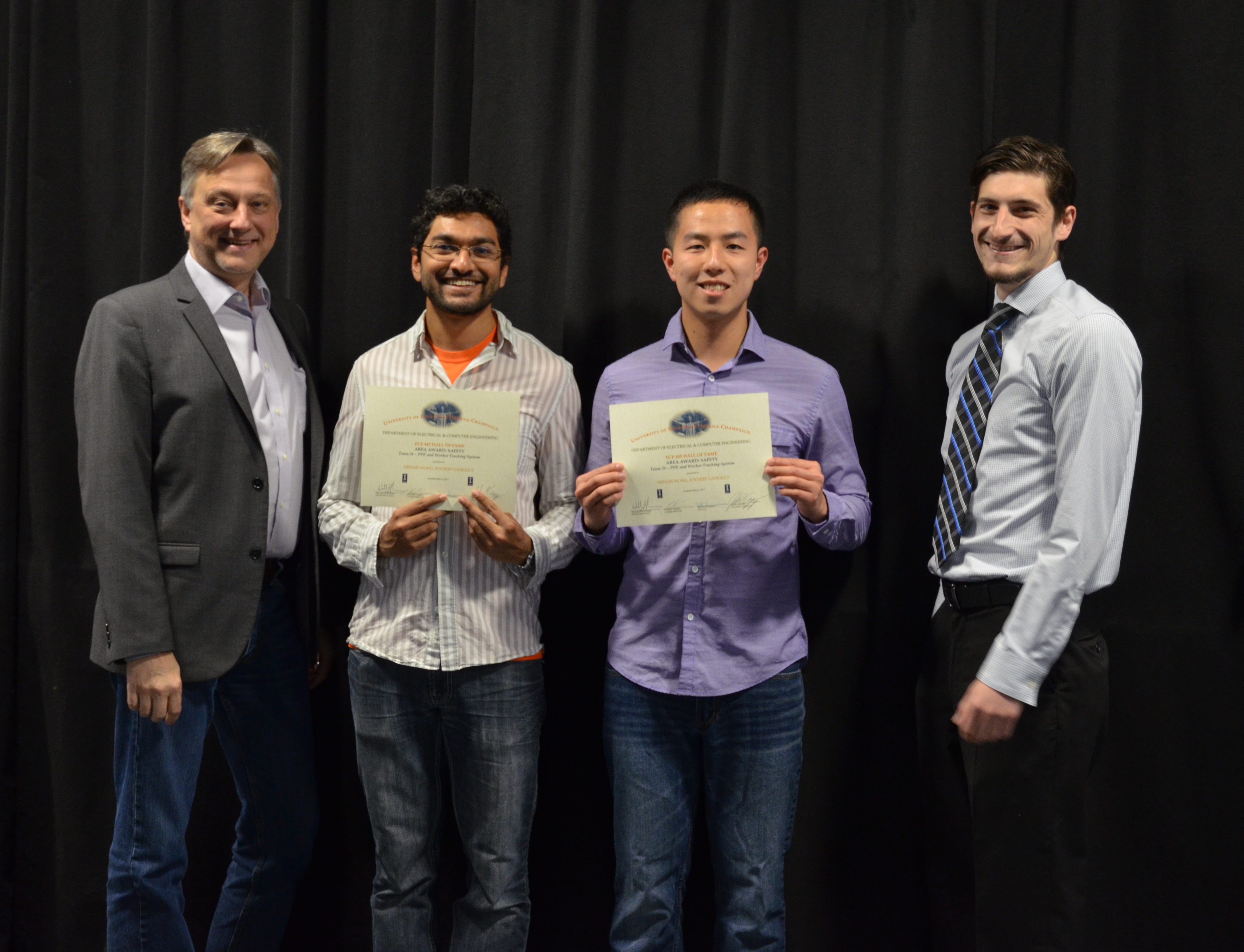 The Area Award for Safety is awarded to Joydeep Ganguly and Dennis Wong for their 'PPE and Worker Tracking System.' Also pictured: Professor Hutchinson, John Capozzo (TA).