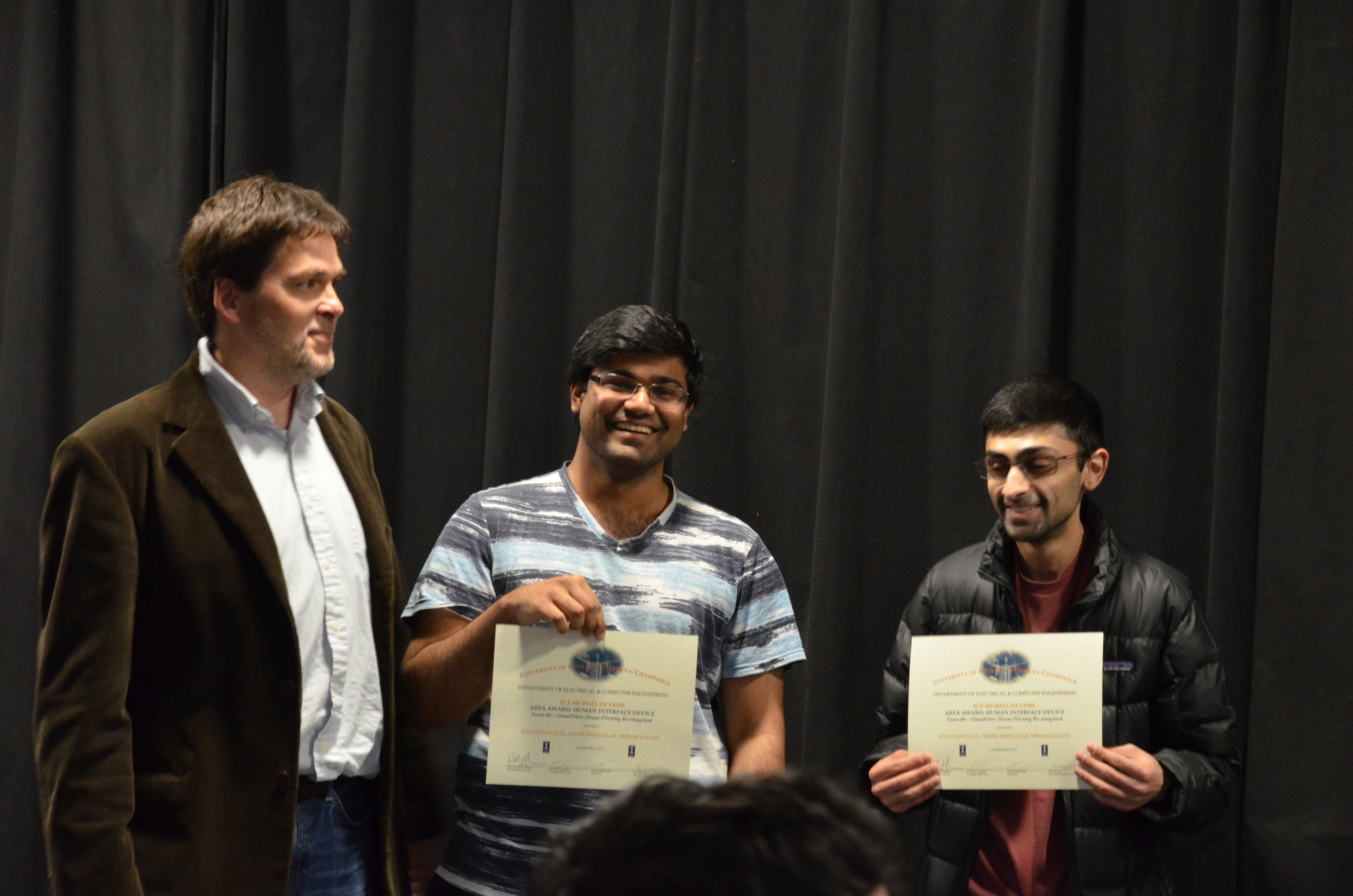 The Area Award for Human Interface Device was given to Jonathan Leal, Mihir Sherlekar and Sriram Raghu for their 'OmniPilot: Drone Piloting Re-imagined'. Also pictured: Professor Oelze.