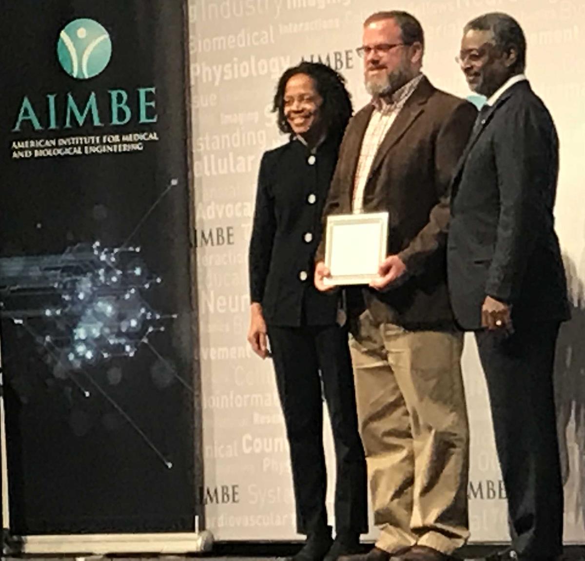 Professor Brad Sutton (center) was inducted as a fellow of the American Institute for Medical and Biological Engineering at the organization's annual meeting in Washington, DC.