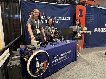 Members of KIMLAB demo robotics at The Grainger College of Engineering conference booth (Left to right: Sean Taylor, Obin Kwon, Chaerim Moon)